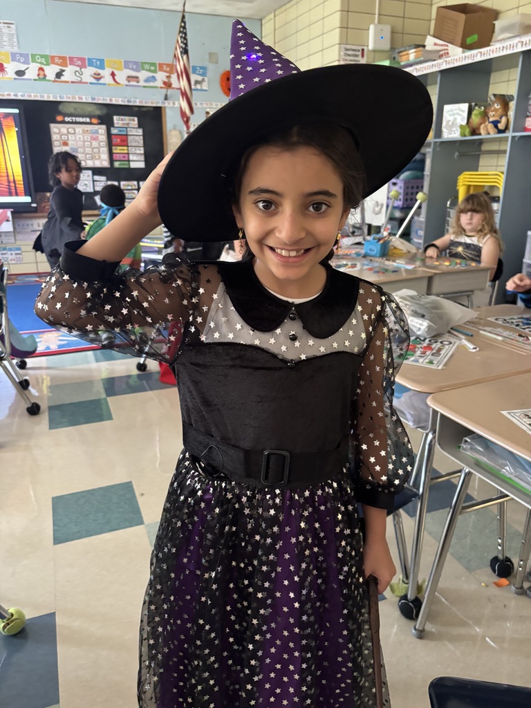 Student smiles with witch's hat