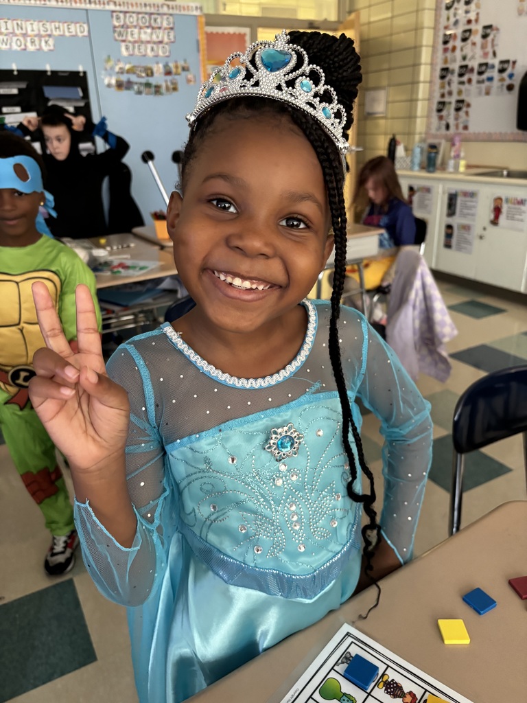 Student holds up peace sign with costume