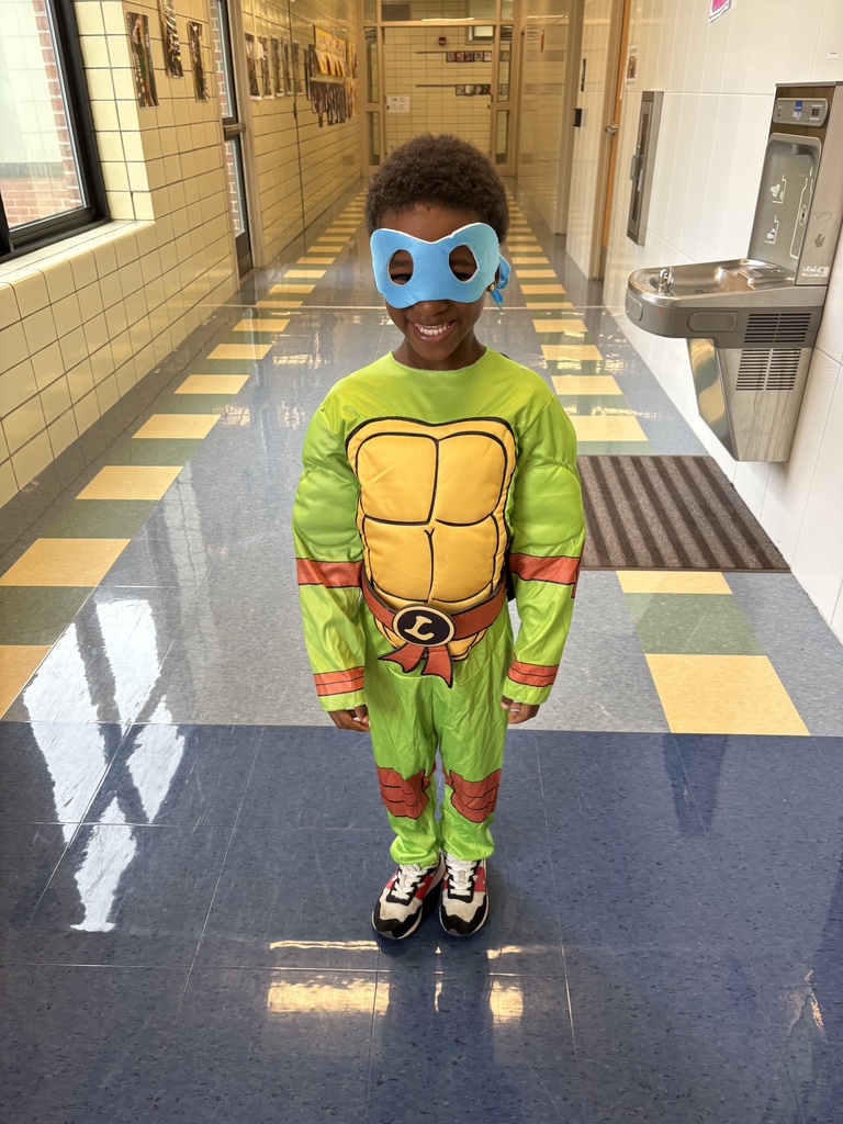 student smiles in ninja turtle costume