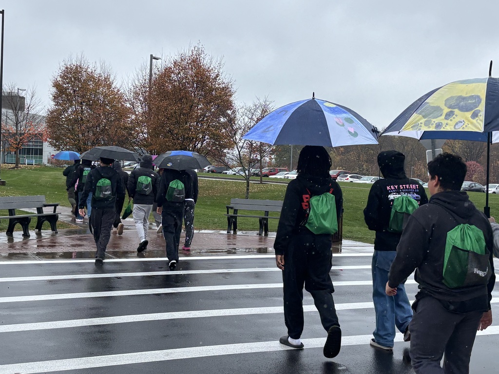 Students walk in the rain on campus