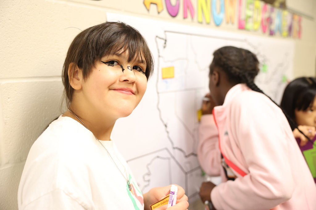 student smiles during map activity 