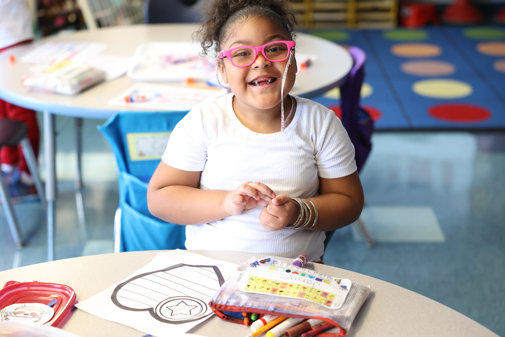 Student smiles while working on project