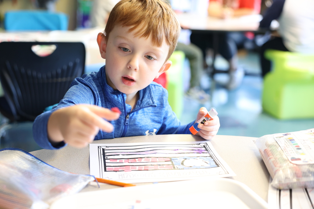 Students pastes paper on american flag