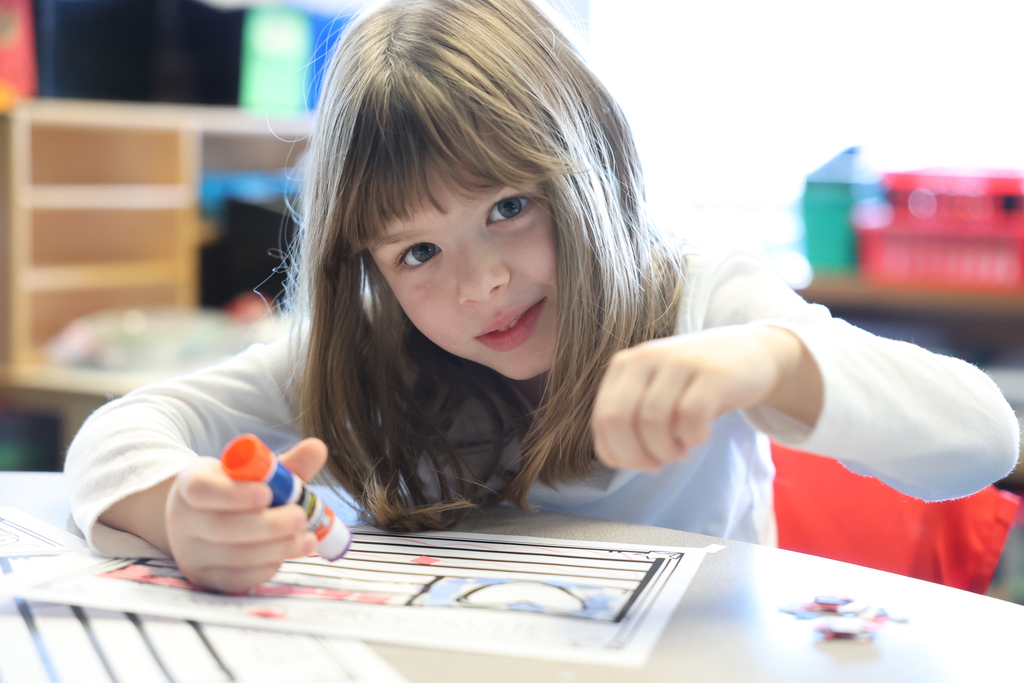 Student looks up from art project