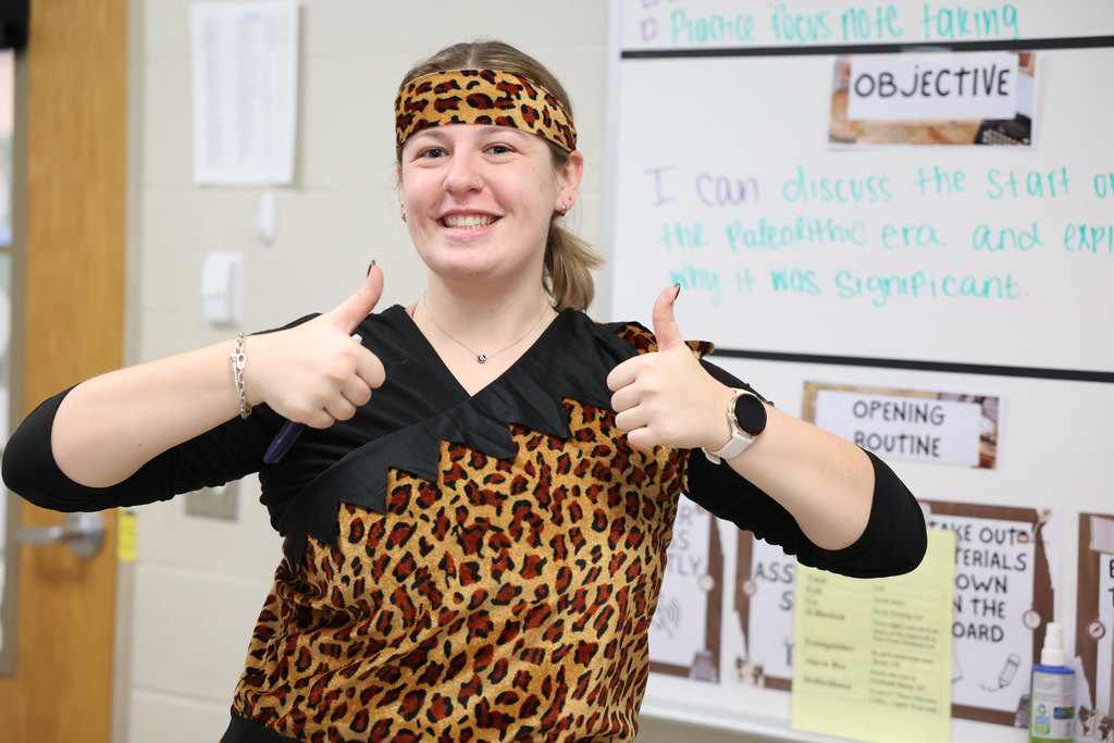 teacher in cave woman outfit with thumbs up