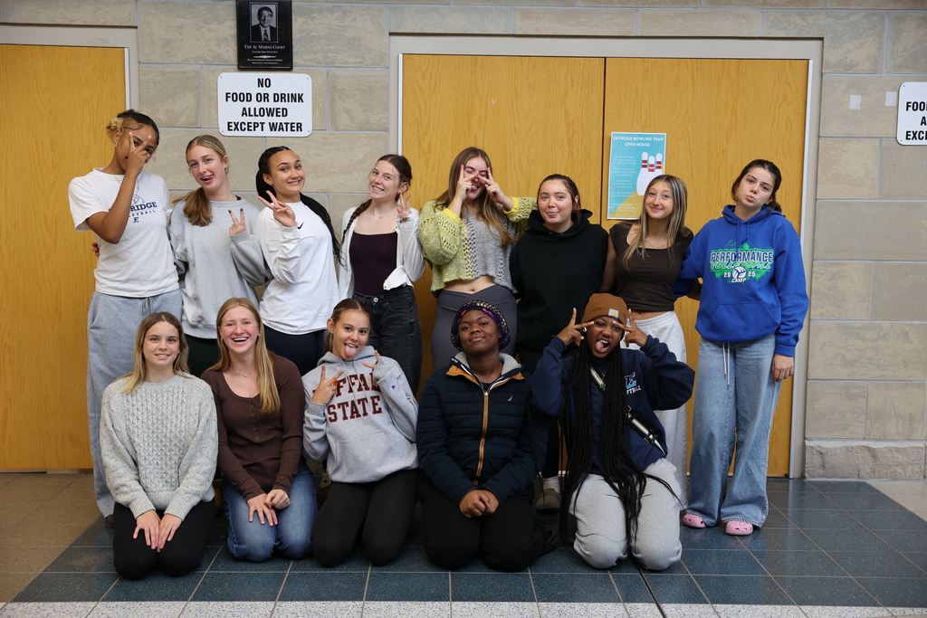 Girls volleyball team poses for a group photo with funny faces