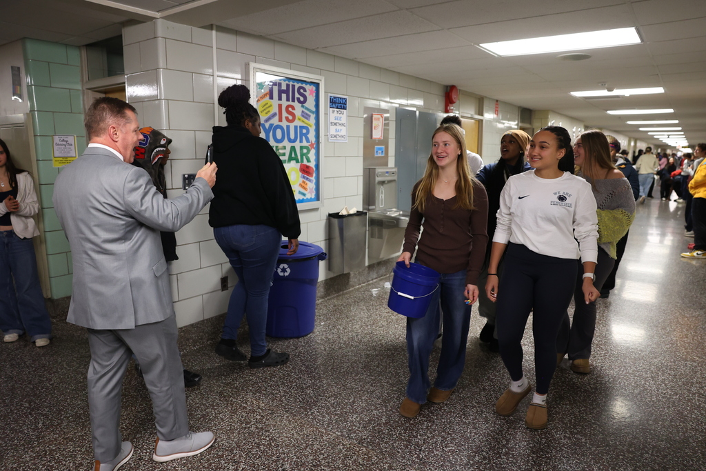 girls volelyball walks the halls and principal takes photo
