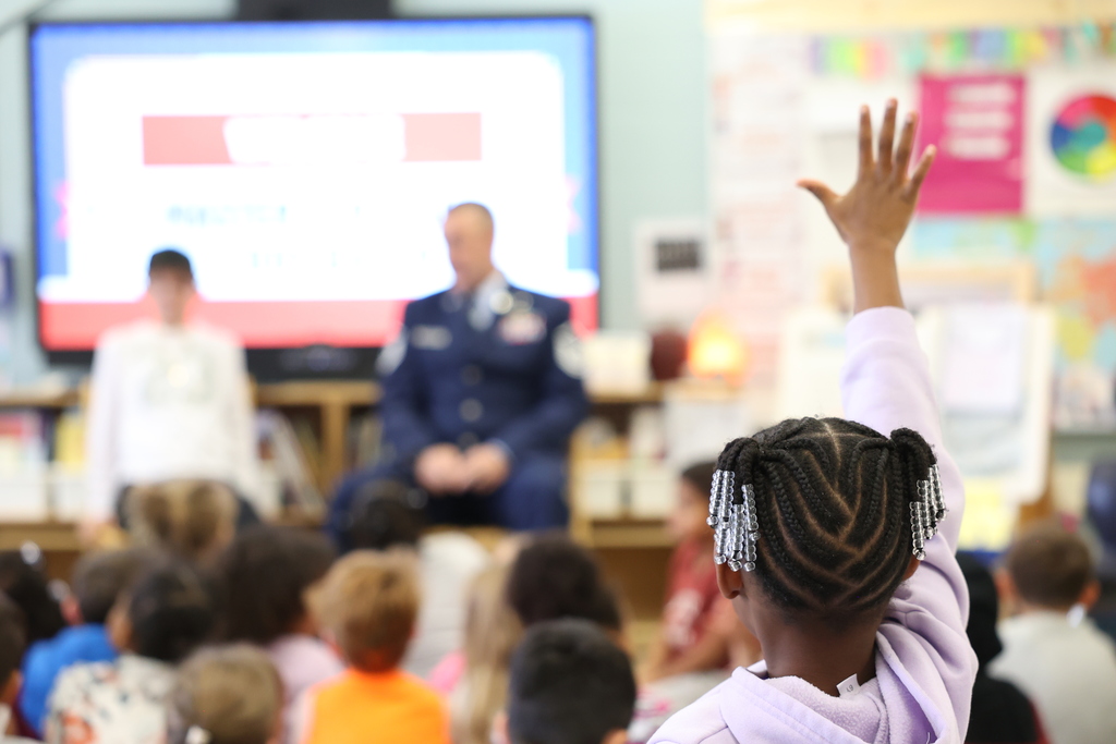 student raises her hand