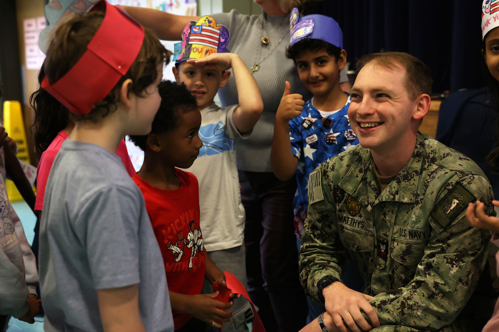 students talk to military officer
