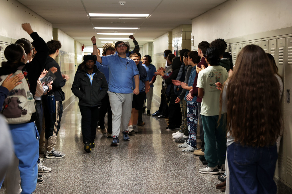 Bowling team is cheered on in the hallway