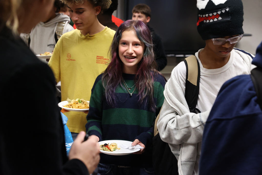 Student smiles with plate