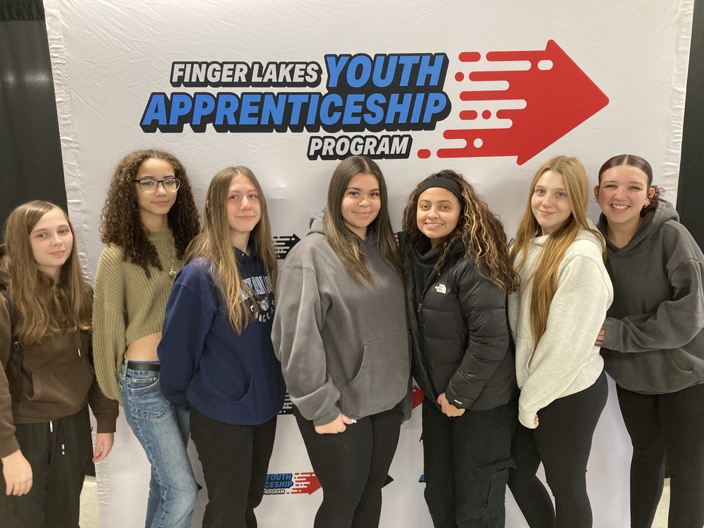 Students attended the Finger Lakes Youth Apprenticeship program and stand in front of a sign