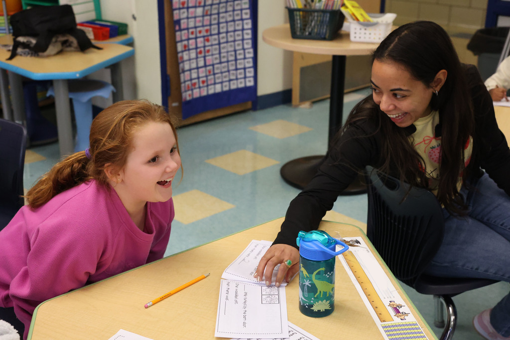 student and teacher laughing