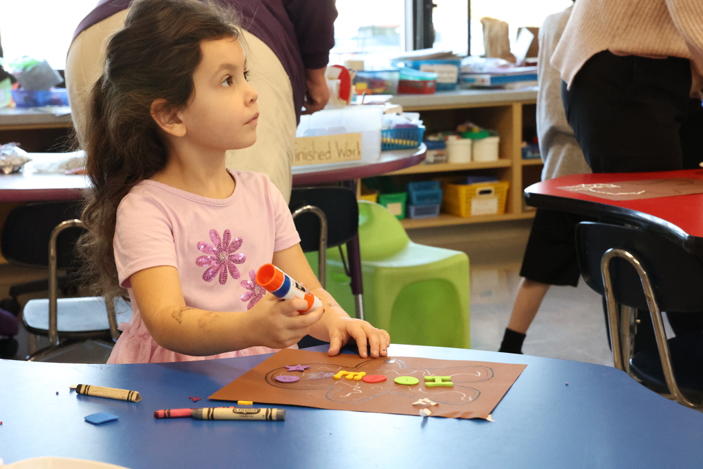 Student looks up while doing gingerbread craft