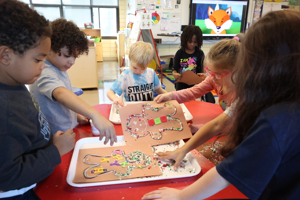 Students work on gingerbread craft at the table