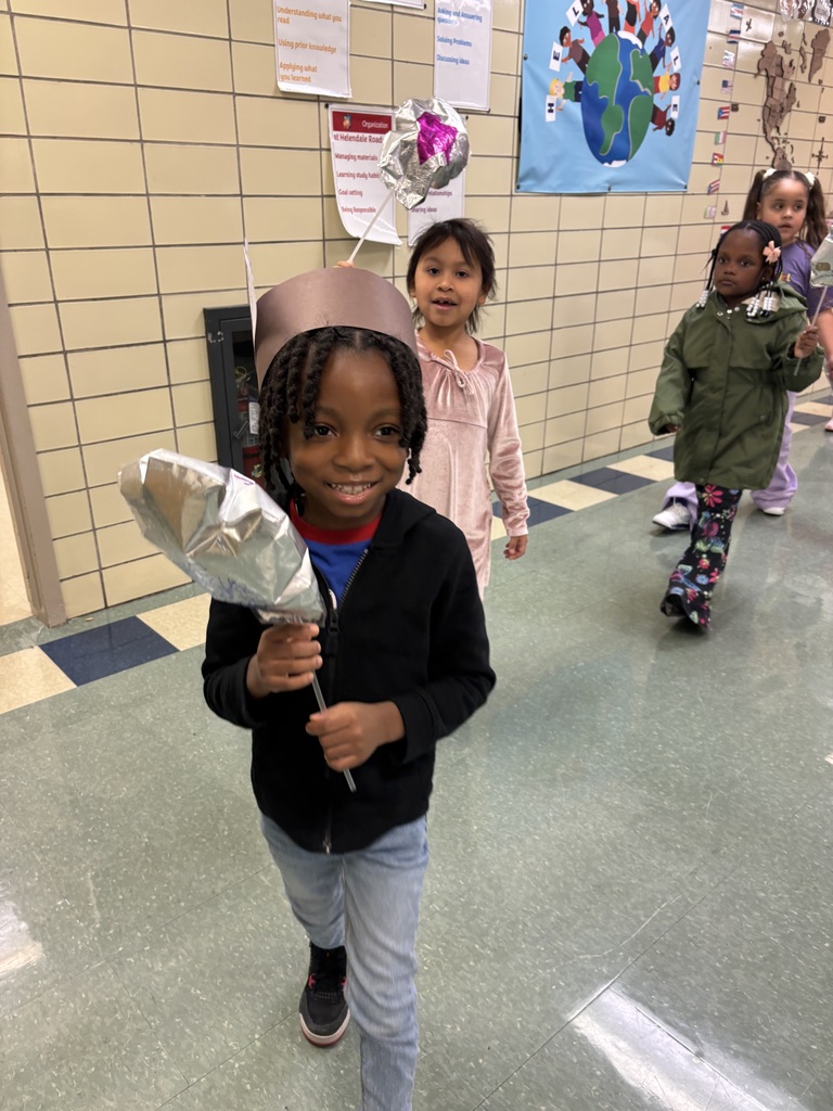 Students hold up balloons for a Macys day inspired school parade