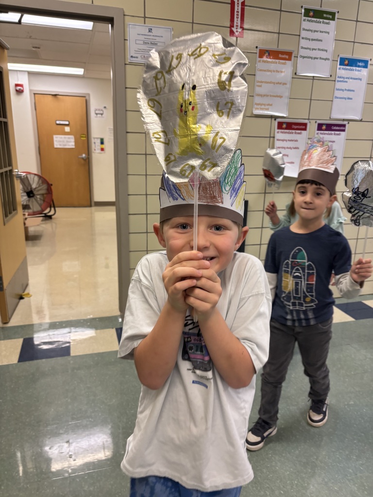 Students hold up balloons for a Macys day inspired school parade