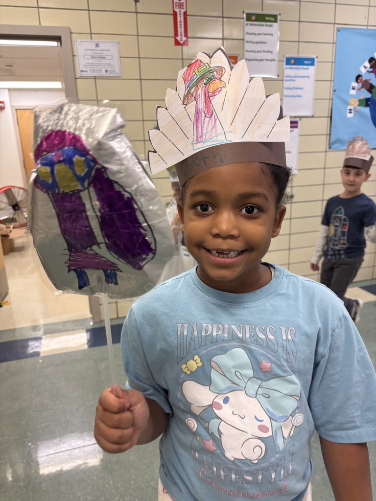 Students hold up balloons for a Macys day inspired school parade