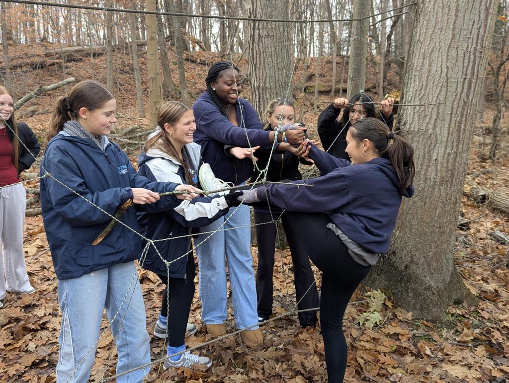 students work together on a tangled string activity