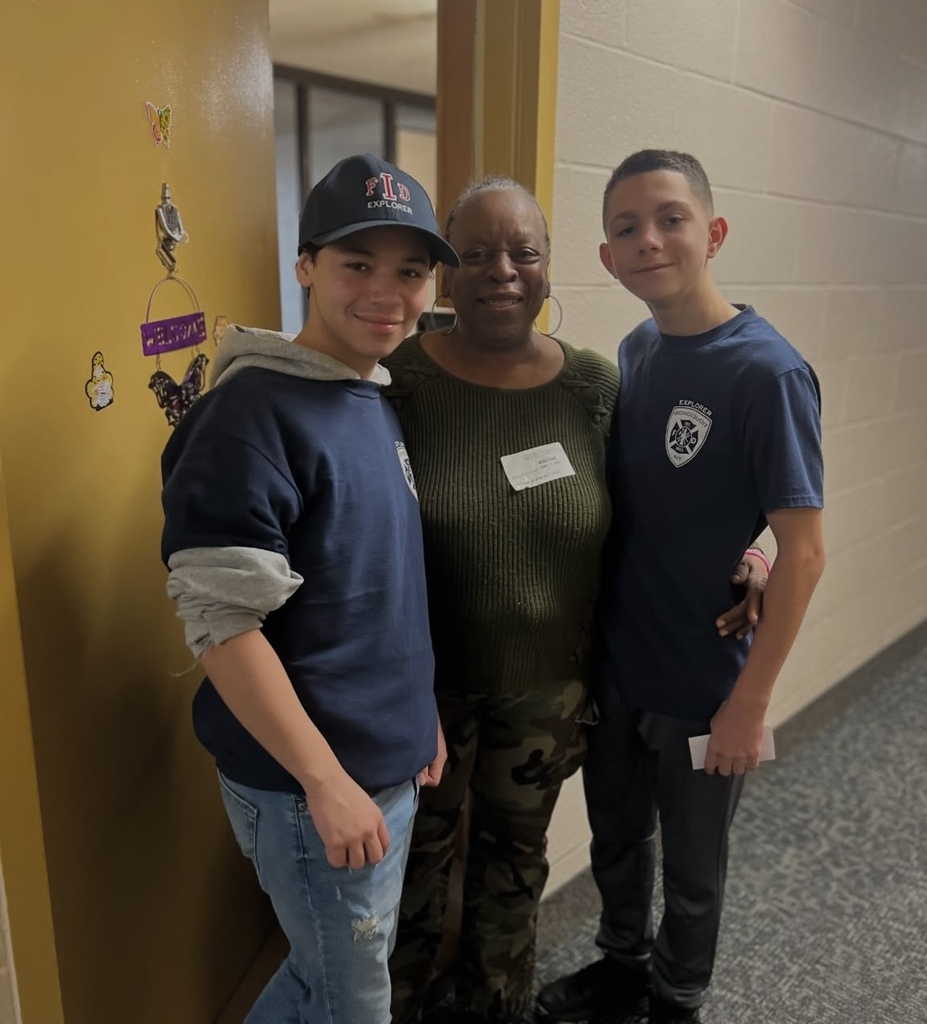 Students pose with a senior that they delivered groceries to