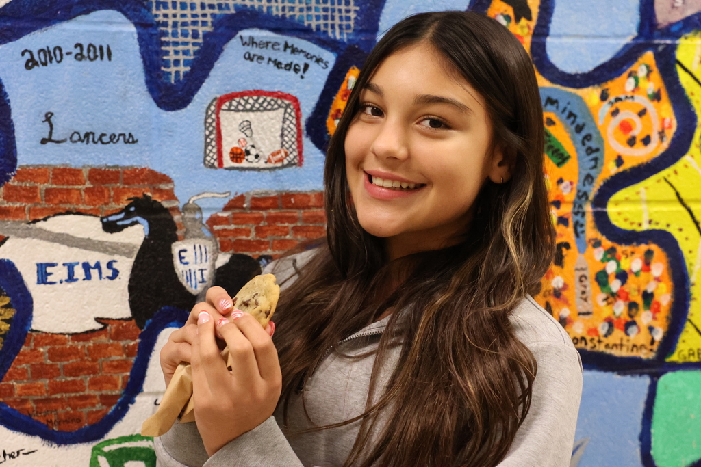 Student holds cookie for high honor roll