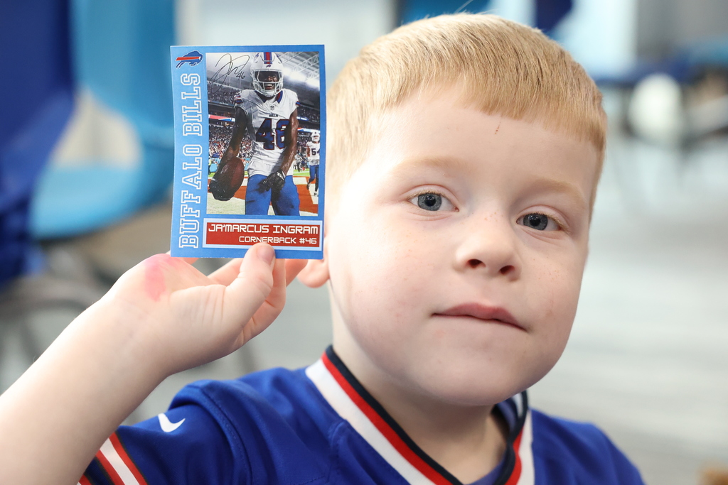 Student holds up JaMarcus buffalo bills card