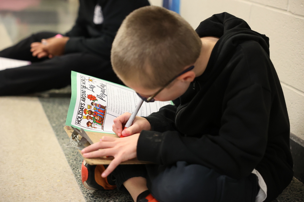 Students writes fact down about the holiday 