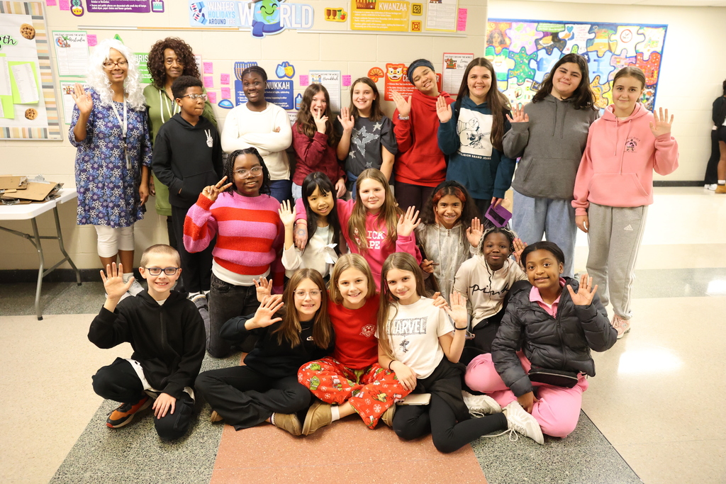 We Have a Dream Club poses for a photo with display