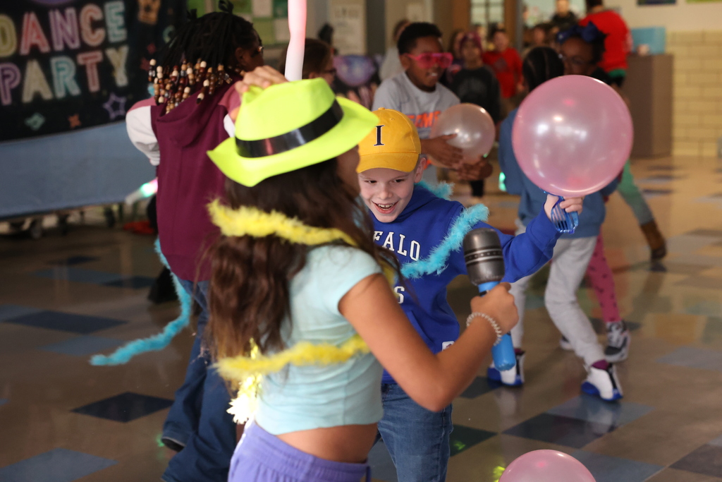 student smiles while dancing