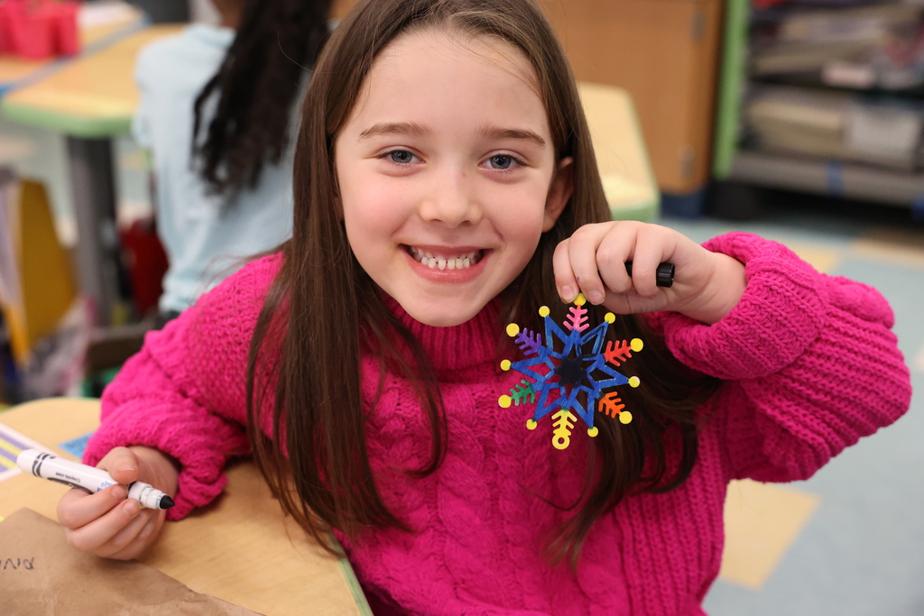 Student holds up snowflake