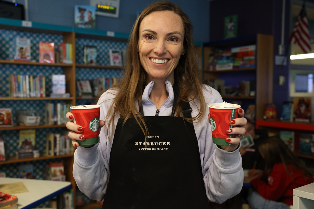 librarian holds up hot cocoa cups