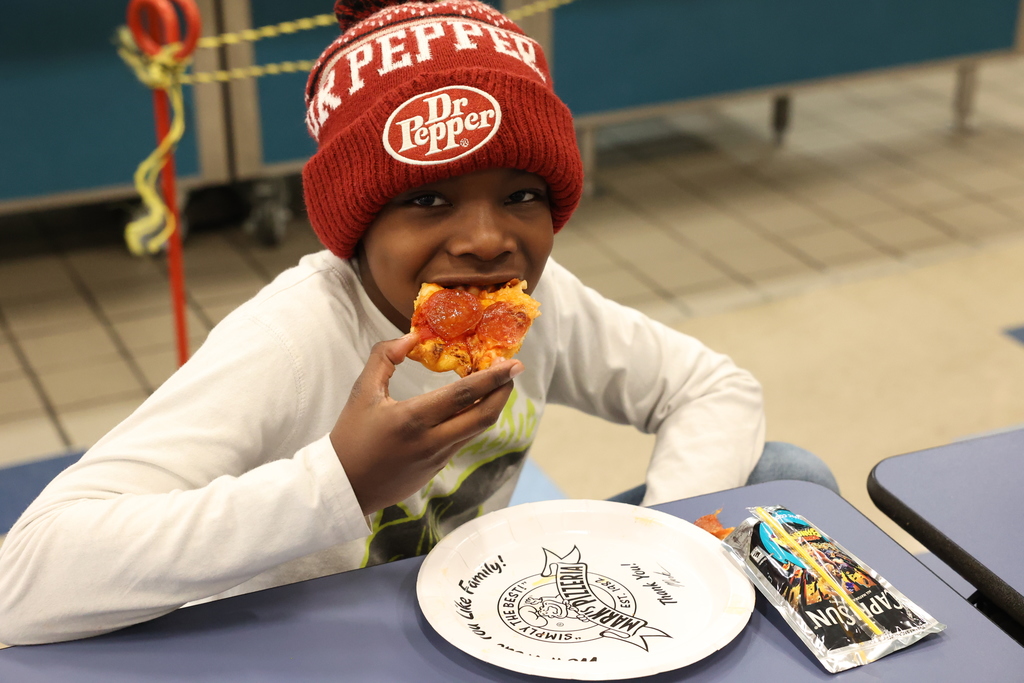 student enjoys pizza