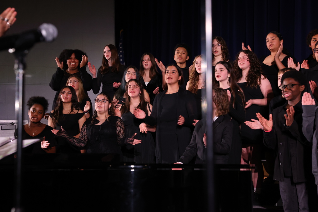 Students clap and sing during a performance