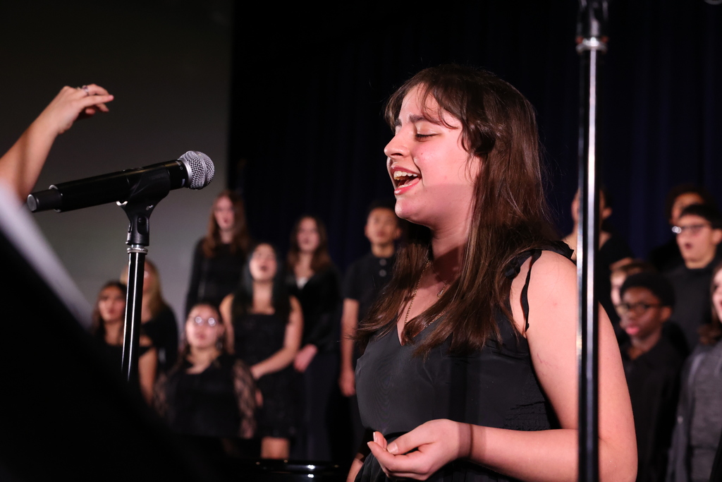 Student sings into the microphone