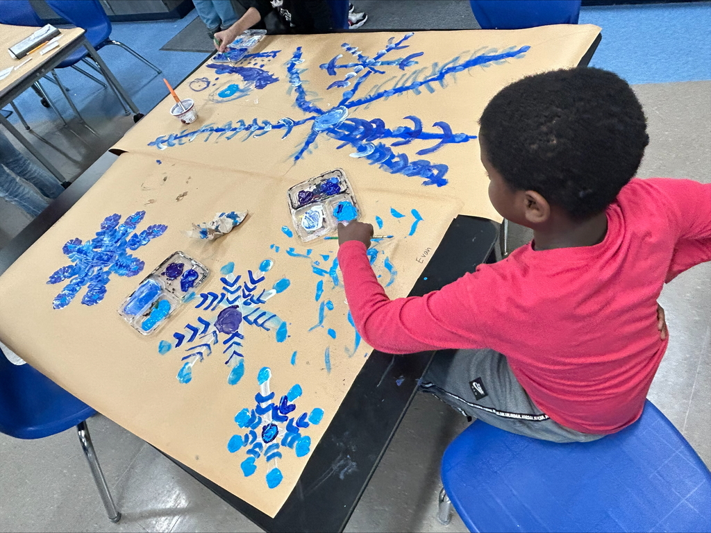 Students paints snowflakes in art class