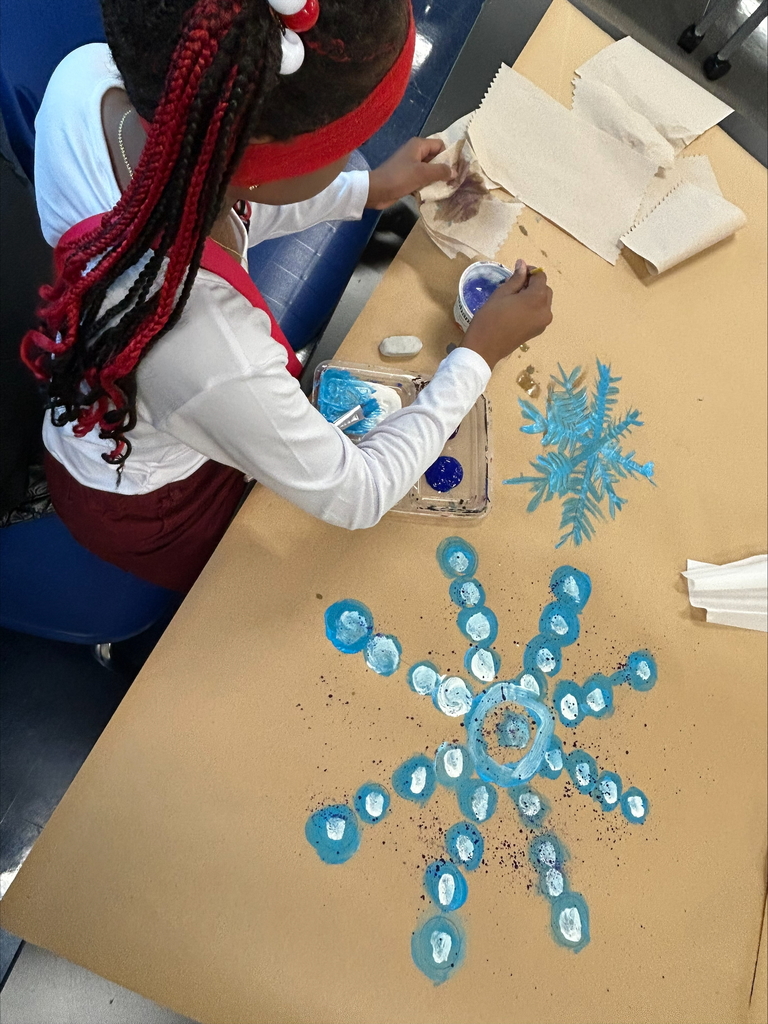 students uses papertowel and paintbrush on project 