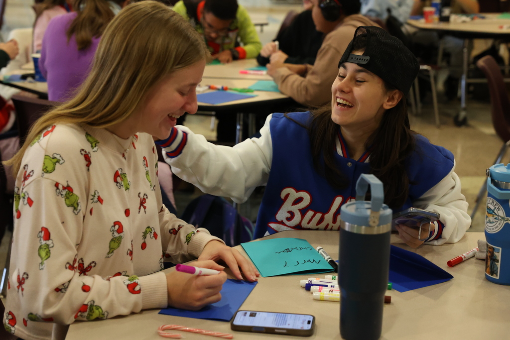 students smile while making holiday cards