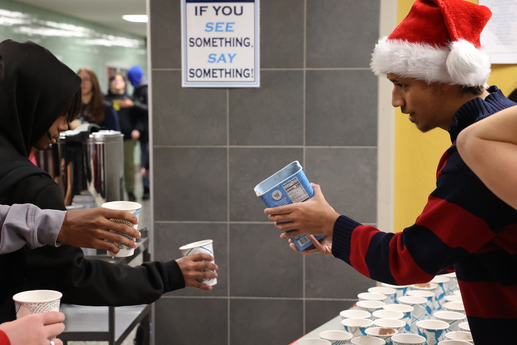 student pours hot cocoa 