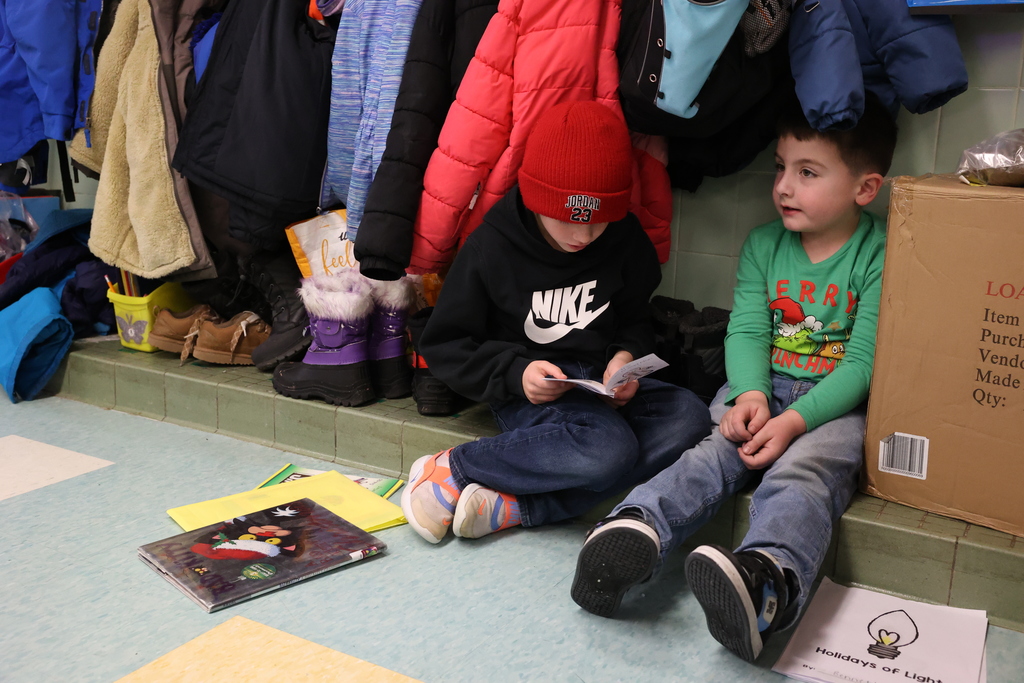 Kids sit and read books together 