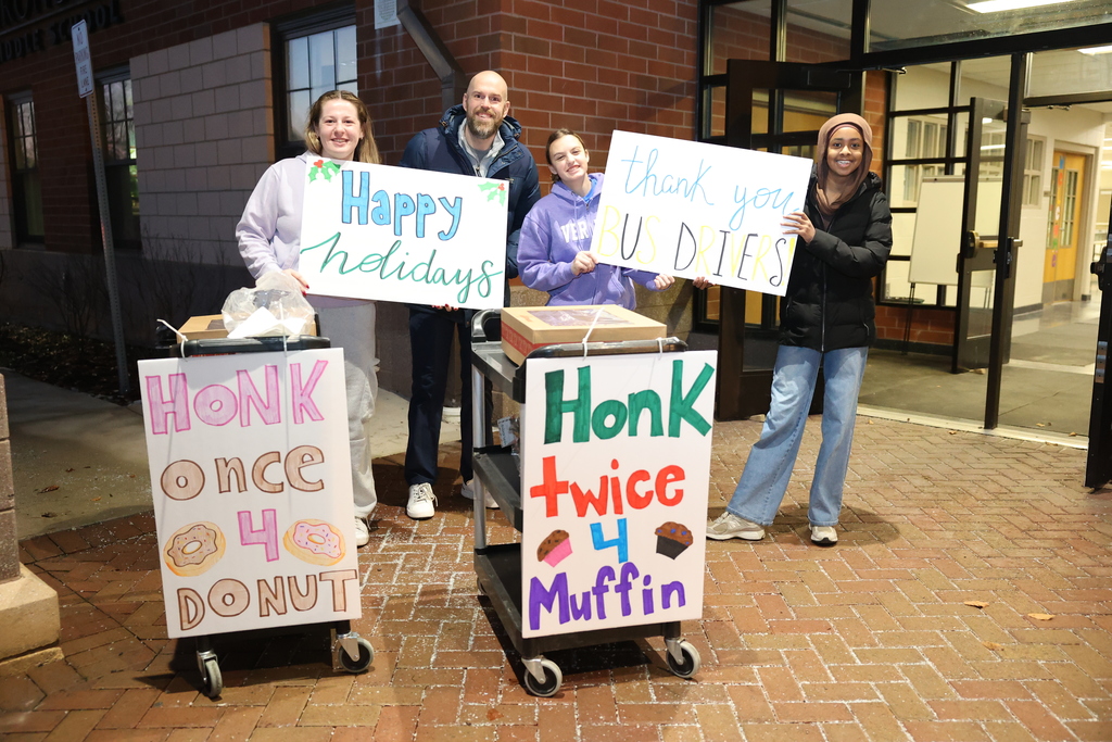 students hold up signs thanking bus driver 
