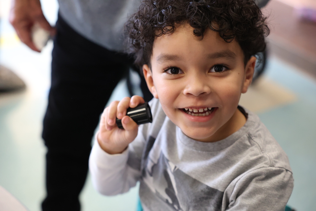 student smiles with film canister