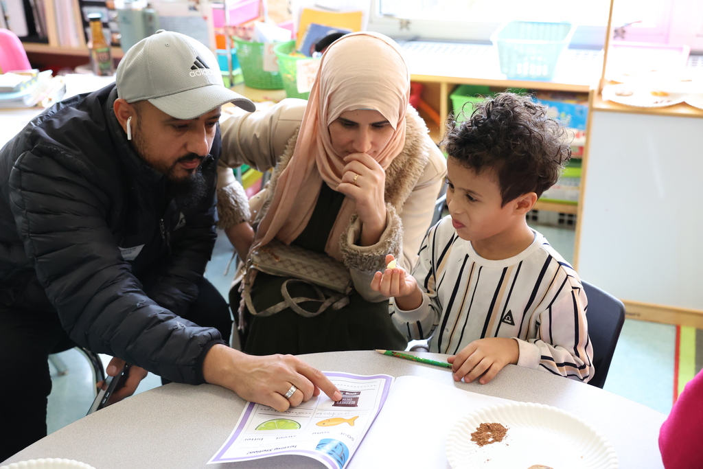 student trys a sour lime with parents