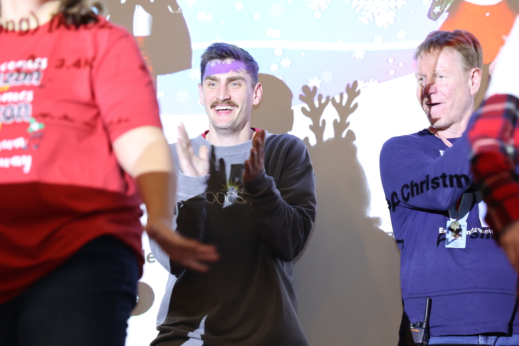 teacher claps on stage