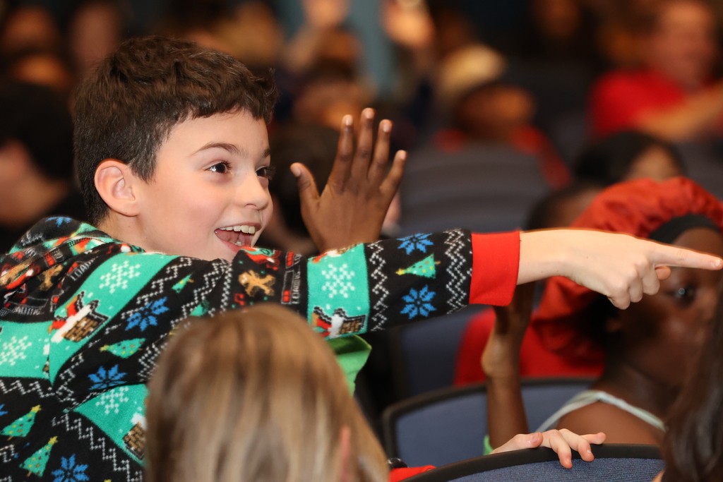 student points to the stage