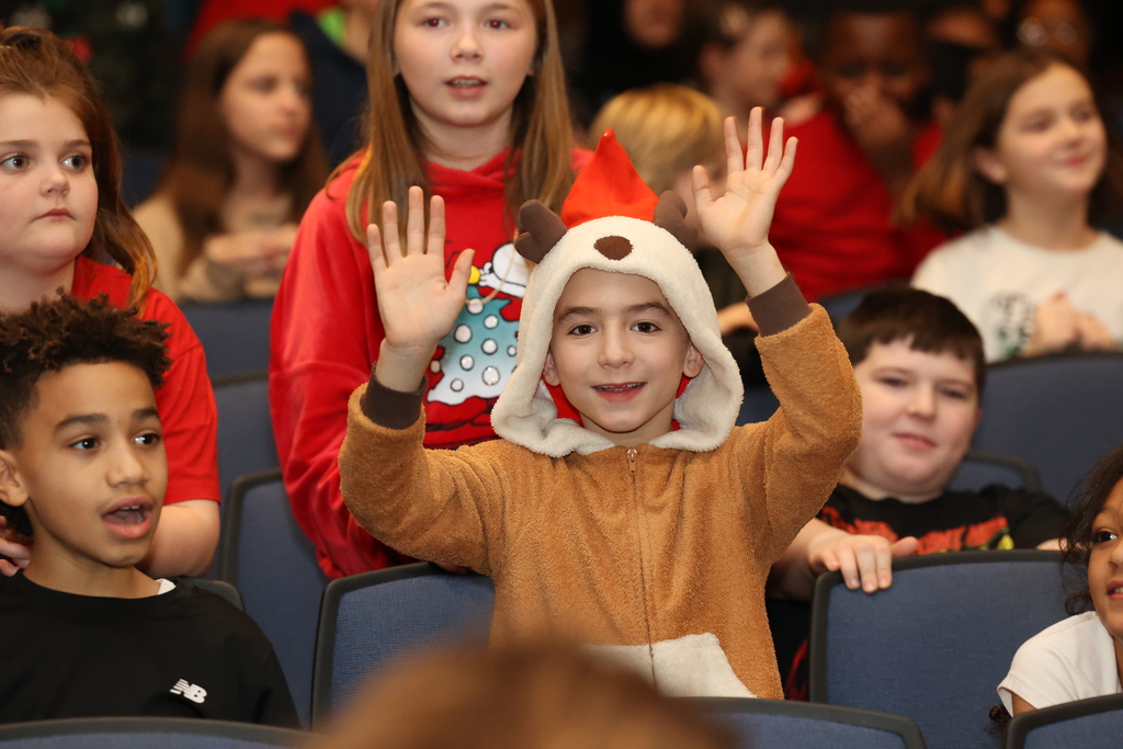student smiles and waves