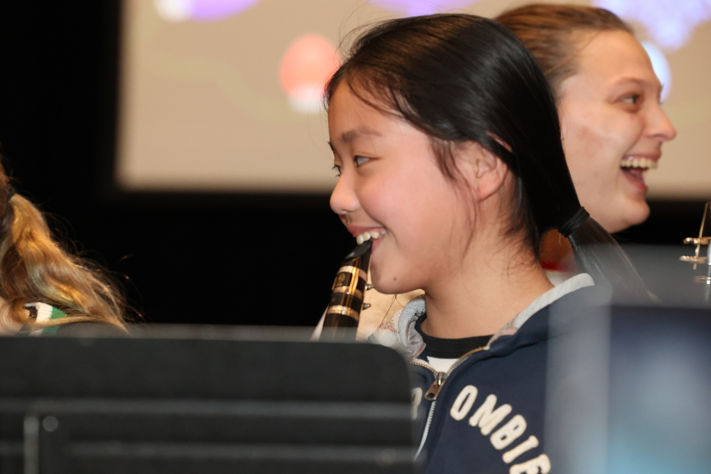 student smiles with clarinet
