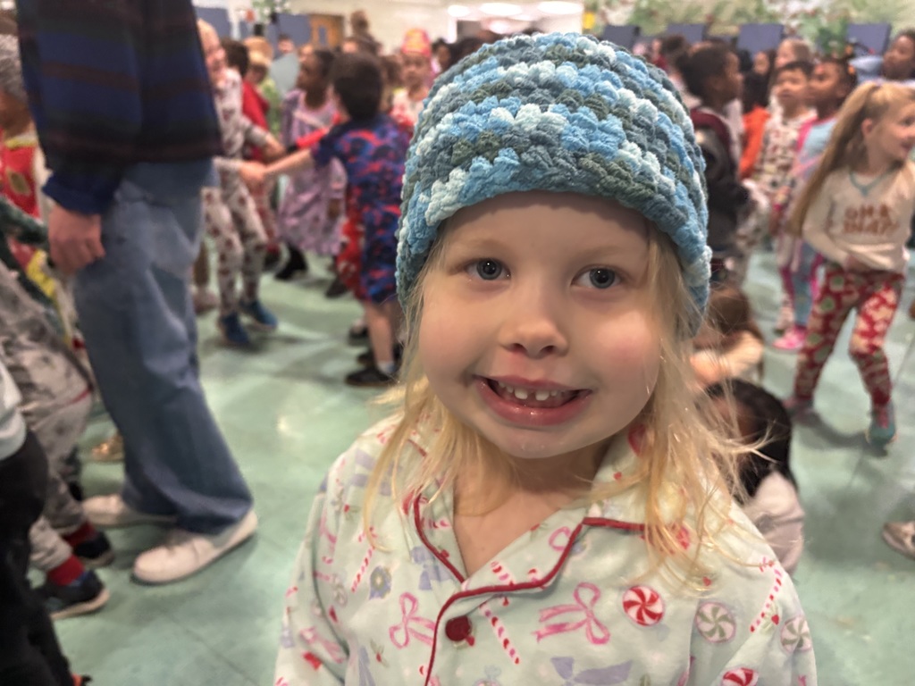 student smiles with hat