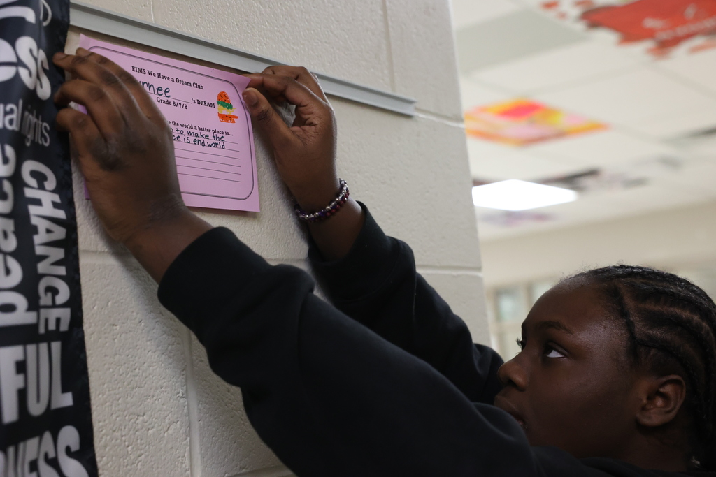 Student tapes worksheet to the wall