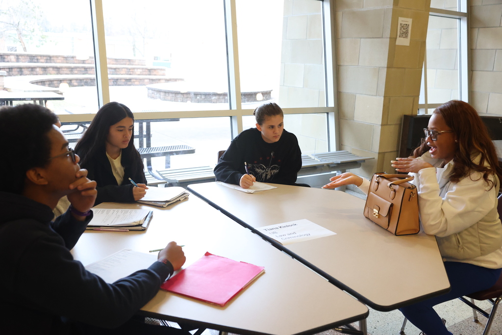 students sit at the table and listen to college student advice