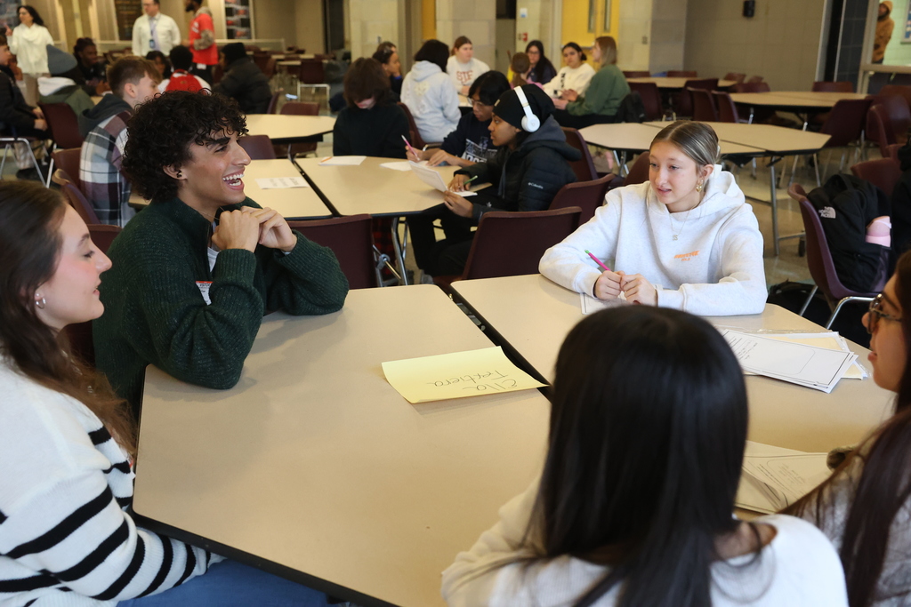 students sit at the table and listen to college student advice